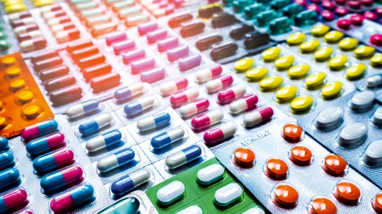 Photo of many colorful tablets in blister packs
