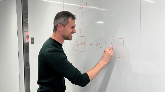 Nasir drawing a diagram on a whiteboard.