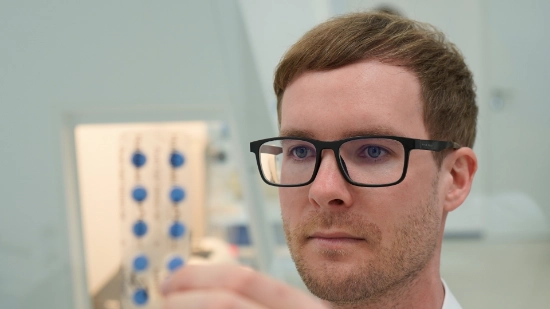 A close-up shot of an Uhlmann expert consulting a client on various packaging solutions.