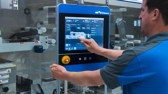 Employee in protective clothing touching a touch display with her finger