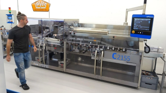 Machine operator passes the cartoner from left to right