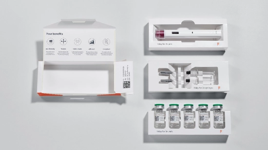 Photo of a folding box with three inserts: for a pen, syringes and bottles.