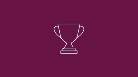 White icon of a trophy on a berry coloured background representing success.