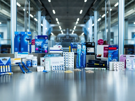 Various medical and consumer goods packages displayed in a production hall.