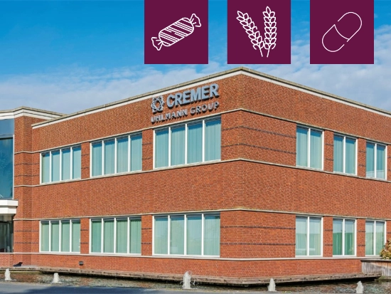 The CREMER Speciaalmachines corporate building, featuring three icons symbolizing foods, agriculture, and pharmaceutical segments.