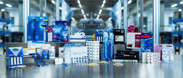 Various medical and consumer goods packages displayed in a production hall.