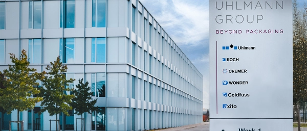 A photo of a building with a sign in front of it displaying the companies' logos.