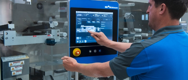 Employee in protective clothing touching a touch display with her finger
