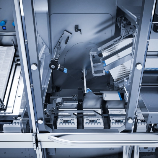 Interior view of an industrial packaging machine showing mechanical components and automated workflows.